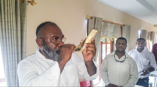 Aharon Sharon demonstrating his shofar-blowing ability